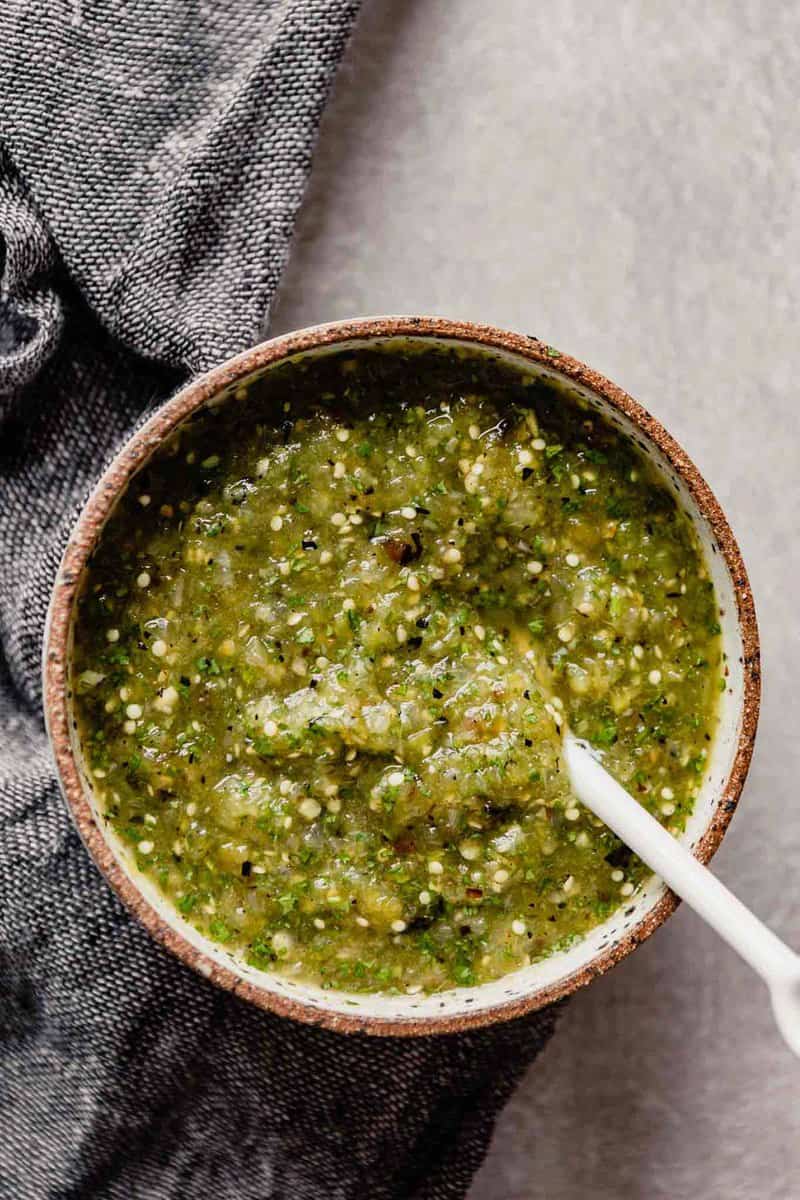 Roasted tomatillos salsa in a bowl.