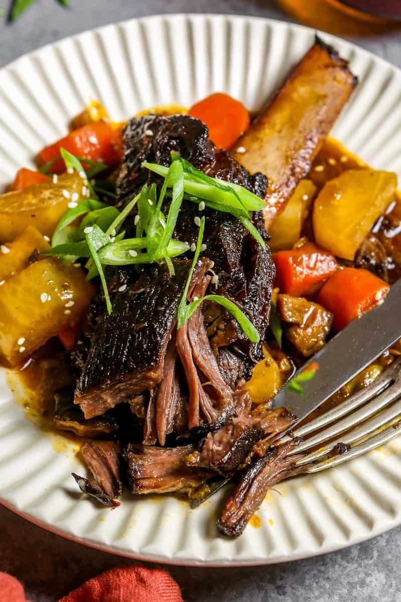 beef short rib in a shallow bowl with stew.