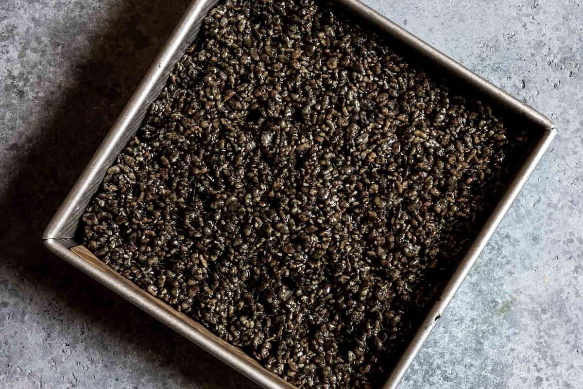 black sesame rice krispies in a baking pan.