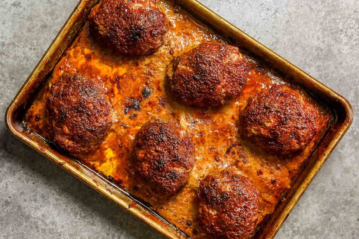 Baked mini meatloaf on a sheeet pan.