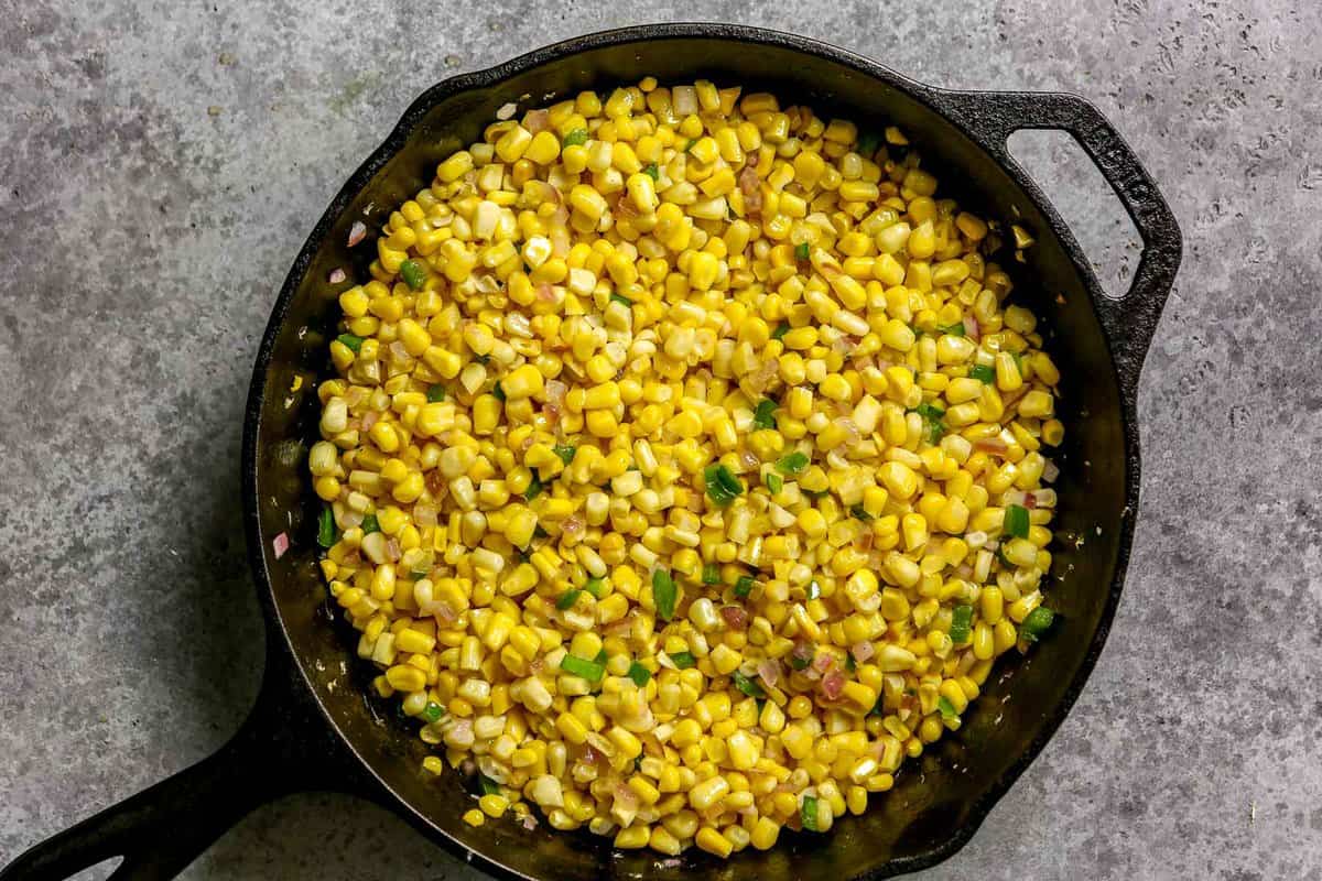Sweet corn, minced jalapeno and minced red onion in a cast-iron skillet. 