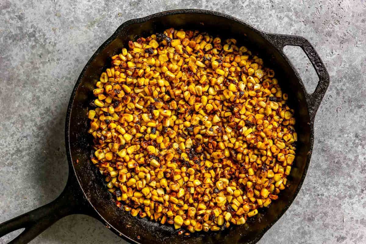 Blackened sweet corn in a cast-iron skillet. 