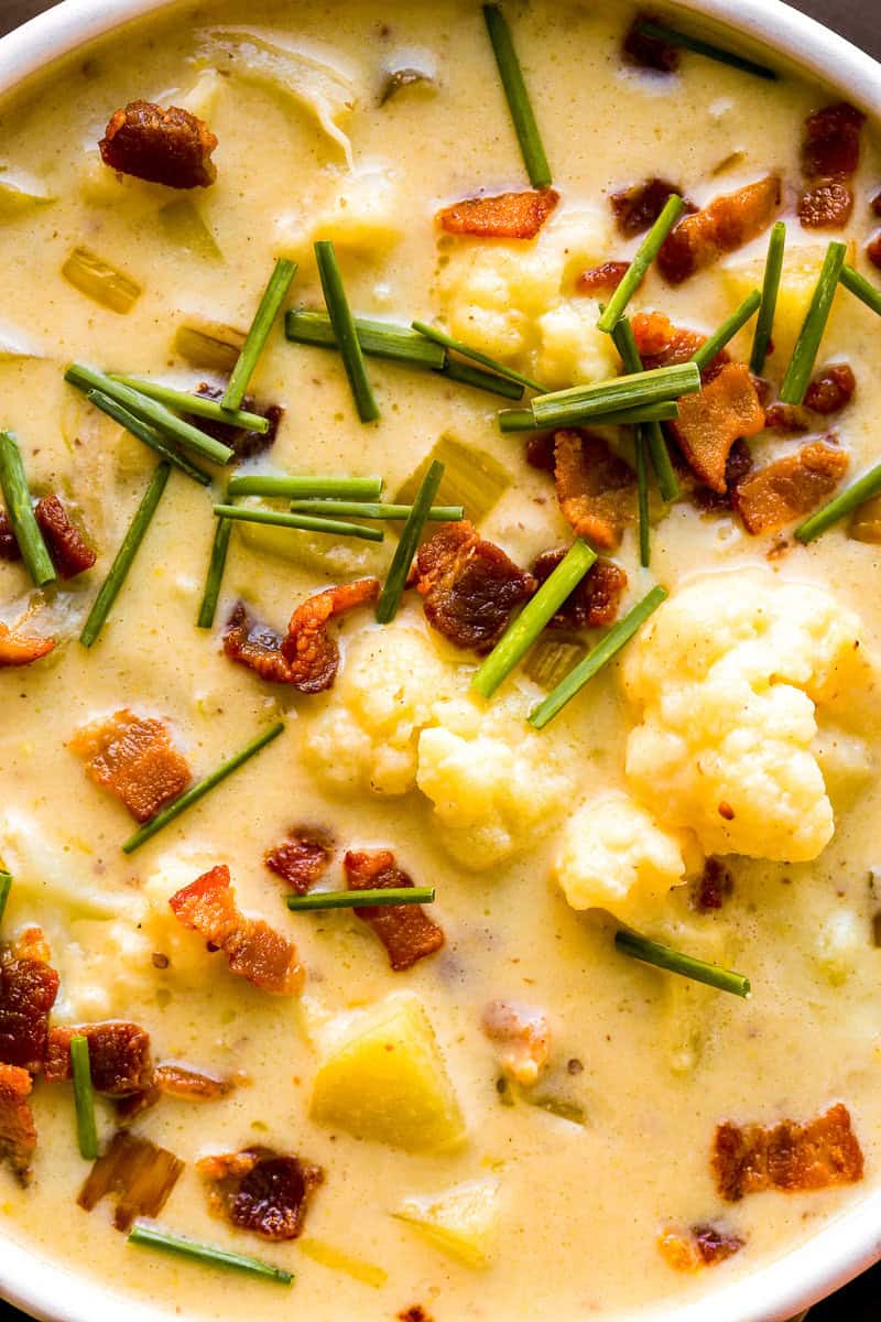 Creamy cauliflower potato leek soup topped with bacon bits and chives.