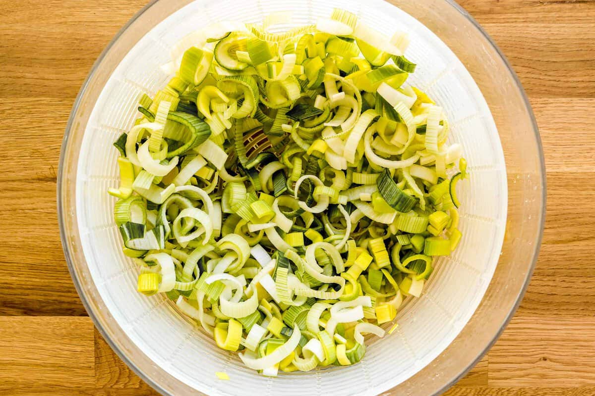 Sliced leeks in a salad spinner.