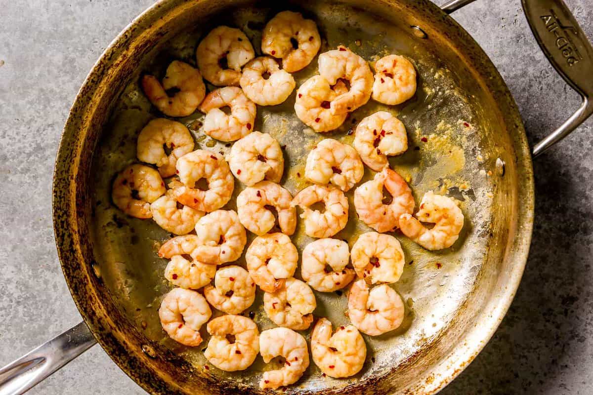 Cooked peeled and deveined shrimp in a large saute pan.