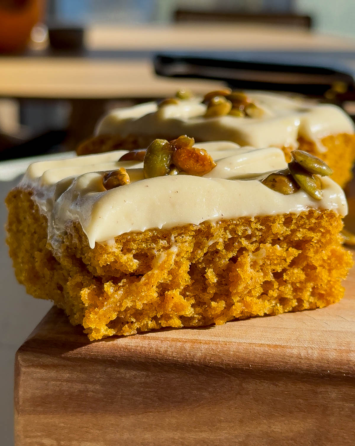 Squash cake with smooth cream cheese frosting spread over top.