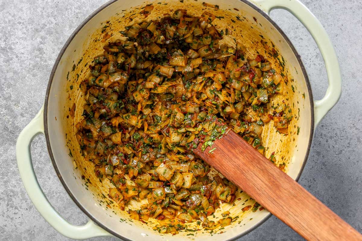 Onions, chipotle, cilantro and cumin cooking down in a large dutch oven.
