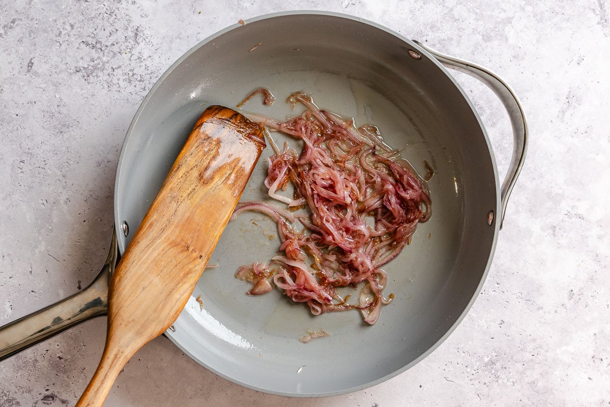 Sliced onion cooked in a nonstick skillet.